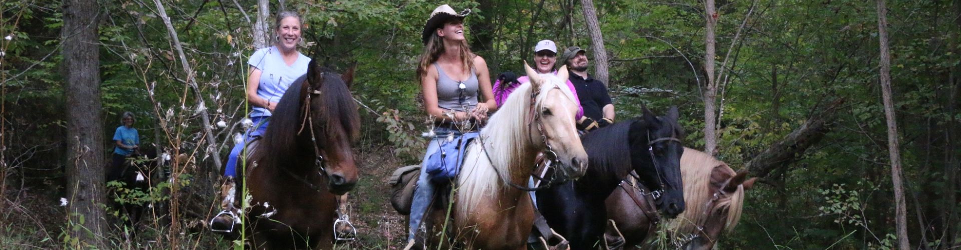 Guests trail riidng and having a great time on horseback